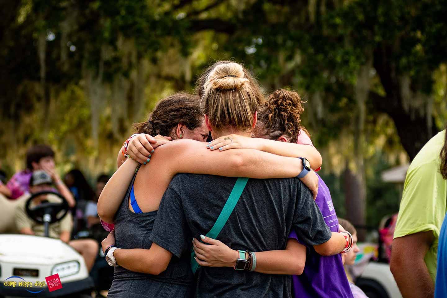 A group of girls hugging at camp