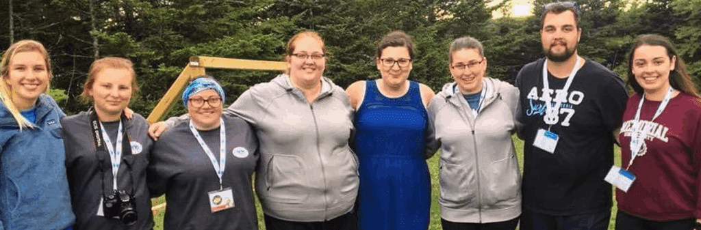 Group of people hugging and smiling