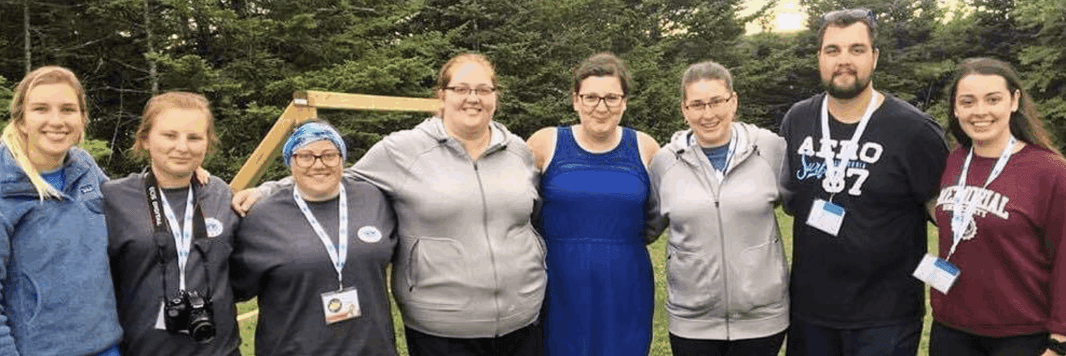 A group of girls hugging at camp