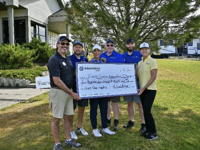 Independence Bank Awards Care Camps Foundation With Donation Check