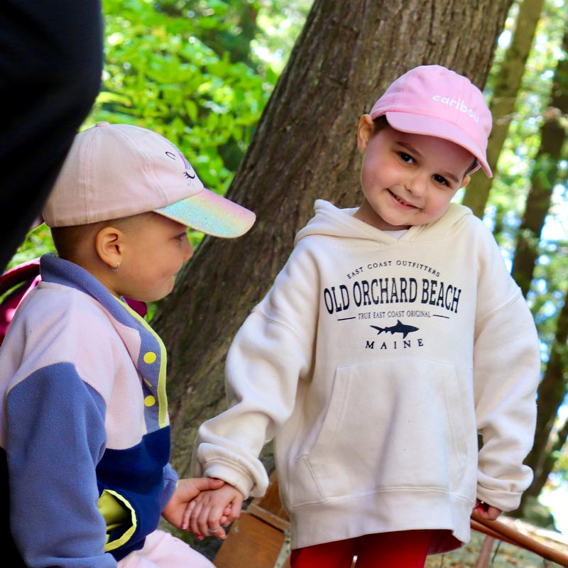 Two smiling children outdoors at Camp Leucan