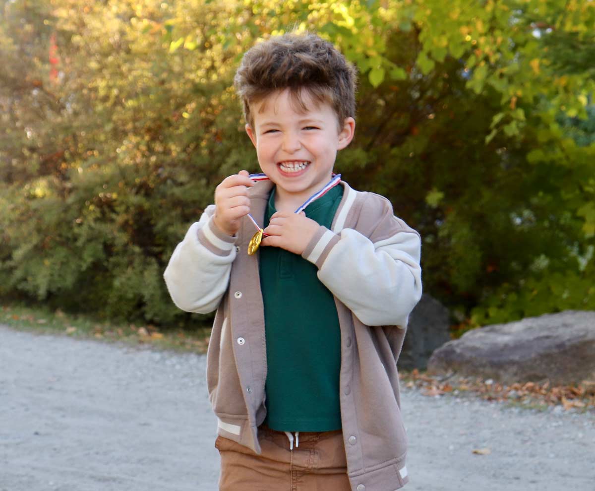 Smiling boy with medal at Camp Leucan